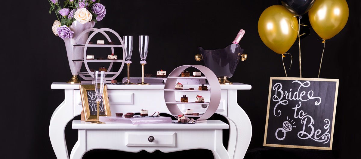 cocktail setting in dark blue and soft shell pink partyware with high tea stands, champage bucket and champagne glasses, sharing tray and pettifour plates