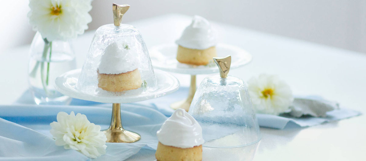 Beautiful cakes presentation for Baking day in white and light blue collours, glass cake stands and tableware