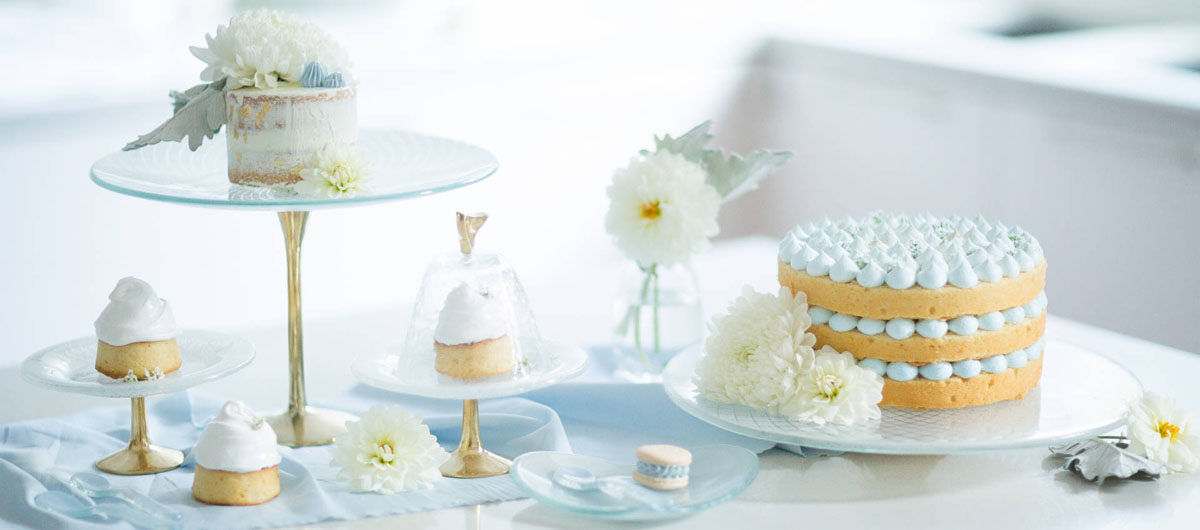 Baking Day Cake Stand Lovely presentation of bakes and cupcakes in a white kitchen in light blue