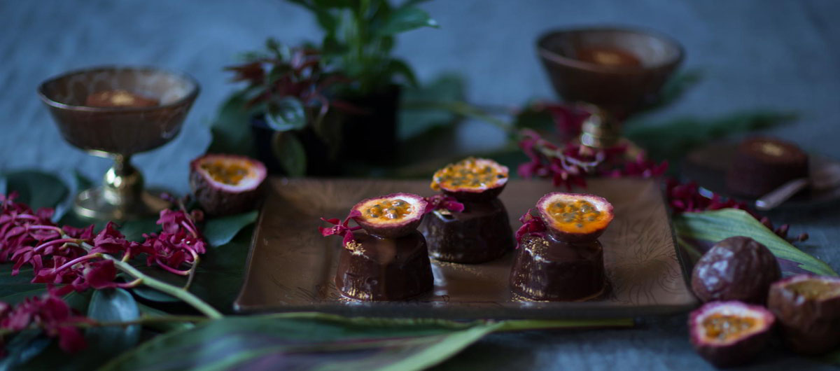 metallic brown dessert plate with floral pattern and raized rim with passion fruit chocolates in jungle decor