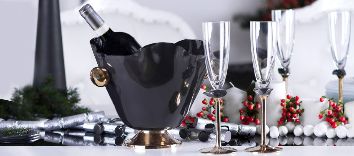 Blue dinner set blue wine ice bucket that sits on a bronze pedestal with handcasted and hand polished bronze handles with beautiful champagne glasses on bronze pedestal and napkin holders in complimentary colours