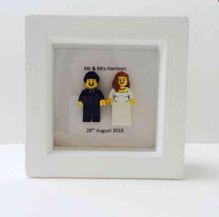 Picture frame with 2 small lego figures refering to the new couple