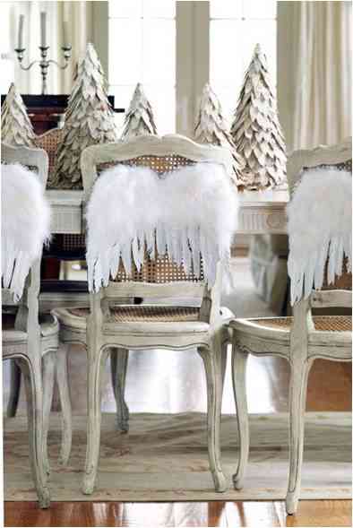 Beautiful angel wings as accessory to the back of a chair for Christmas lunch