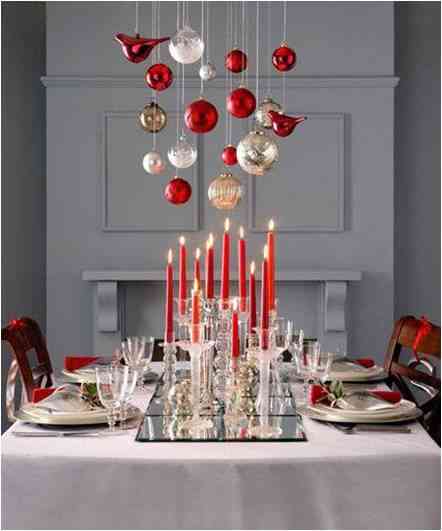 Christmas table setting in red and white with hanging from the top decorations