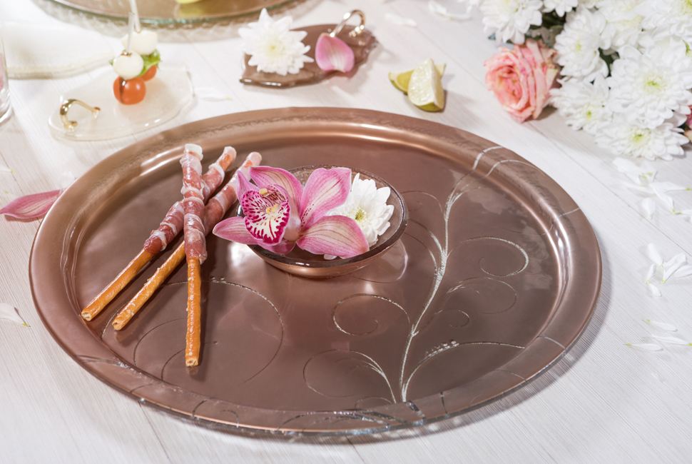 Serving Trays Elyn is a round serving dip platter teamed with a small bowl, both in dark doe brown with our vivid Vivace pattern. Elyn is presenting breadsticks wrapped in prosciutto and the bowl is used for small flowers