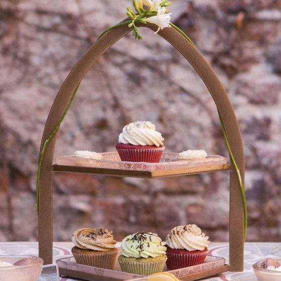 2 tier cake stand covered with cupcakes 