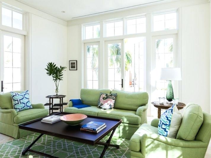 Green livingroom with dark coffee table and white walls