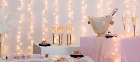 party plates elegant table setting in champagne colour and soft shell pink with ice bucket, champagne flutes and charger plates with jello shots with flowers